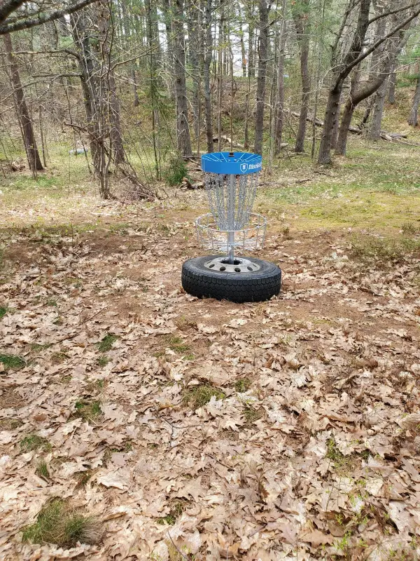 A disc golf basket on the course
