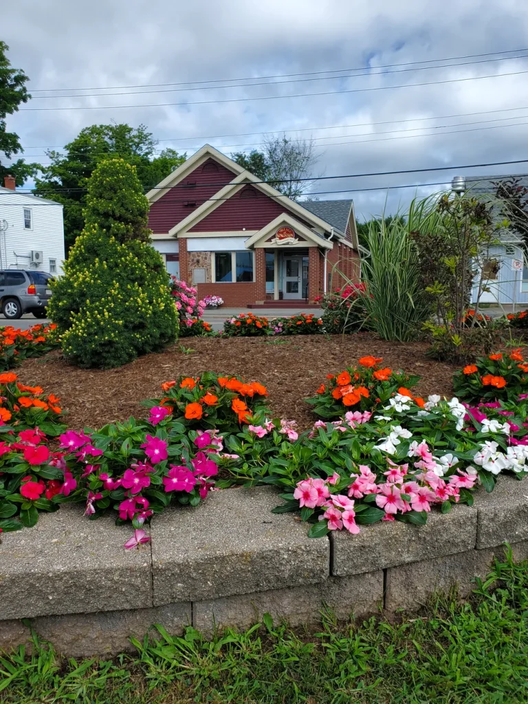 The Village Office with flower beds out front